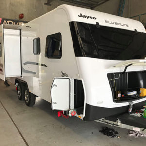 Redfoot Levelling - A white rv is parked in a garage.