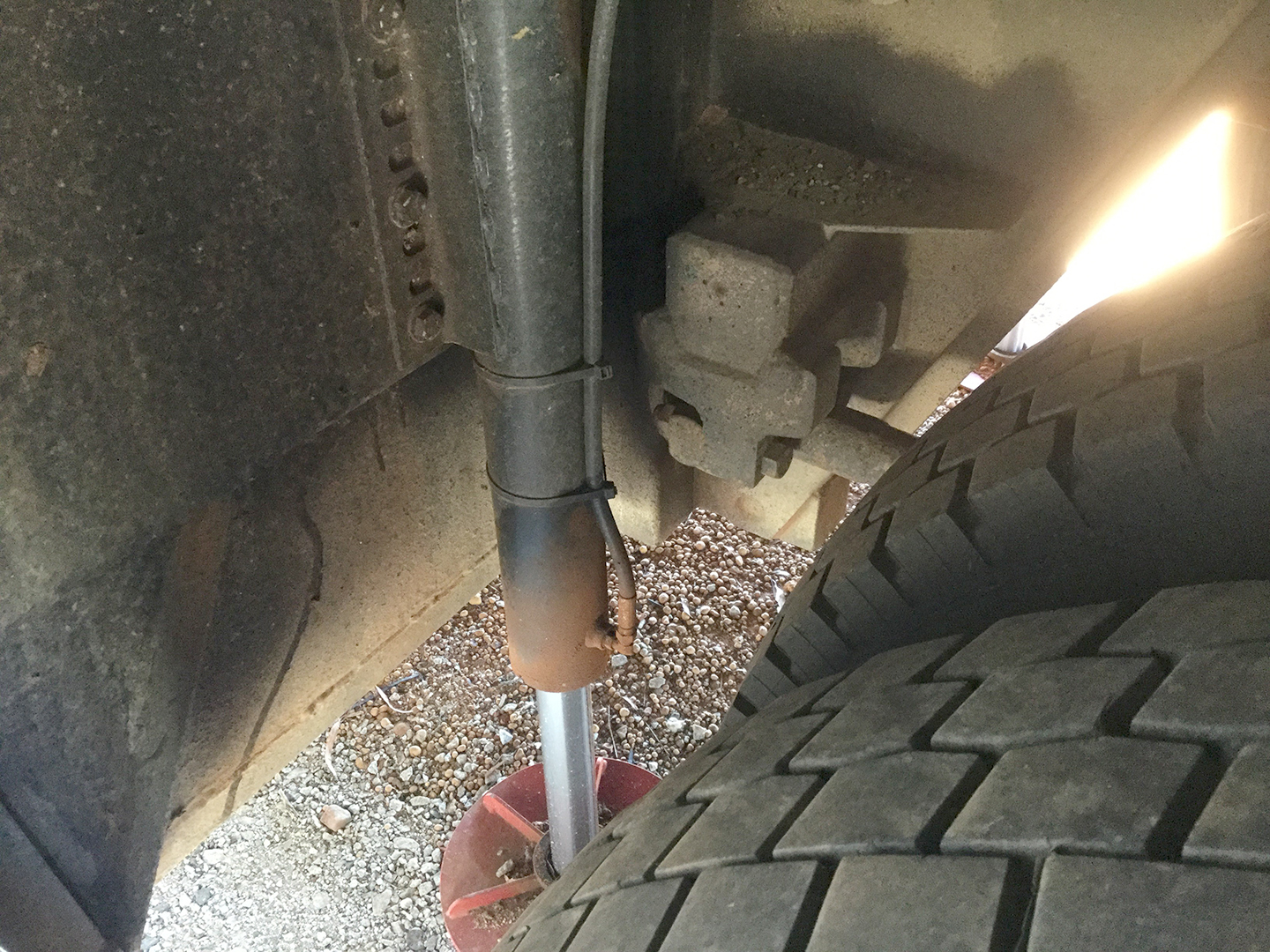 Redfoot Levelling - The underside of a truck with a tire on it.