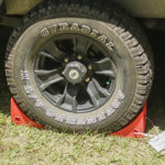 Redfoot Levelling - A black Redfoot Levelling Super Chock with outrigger pads.