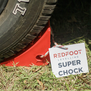 Redfoot Levelling - A Redfoot Levelling Super Chock with a sign on it.