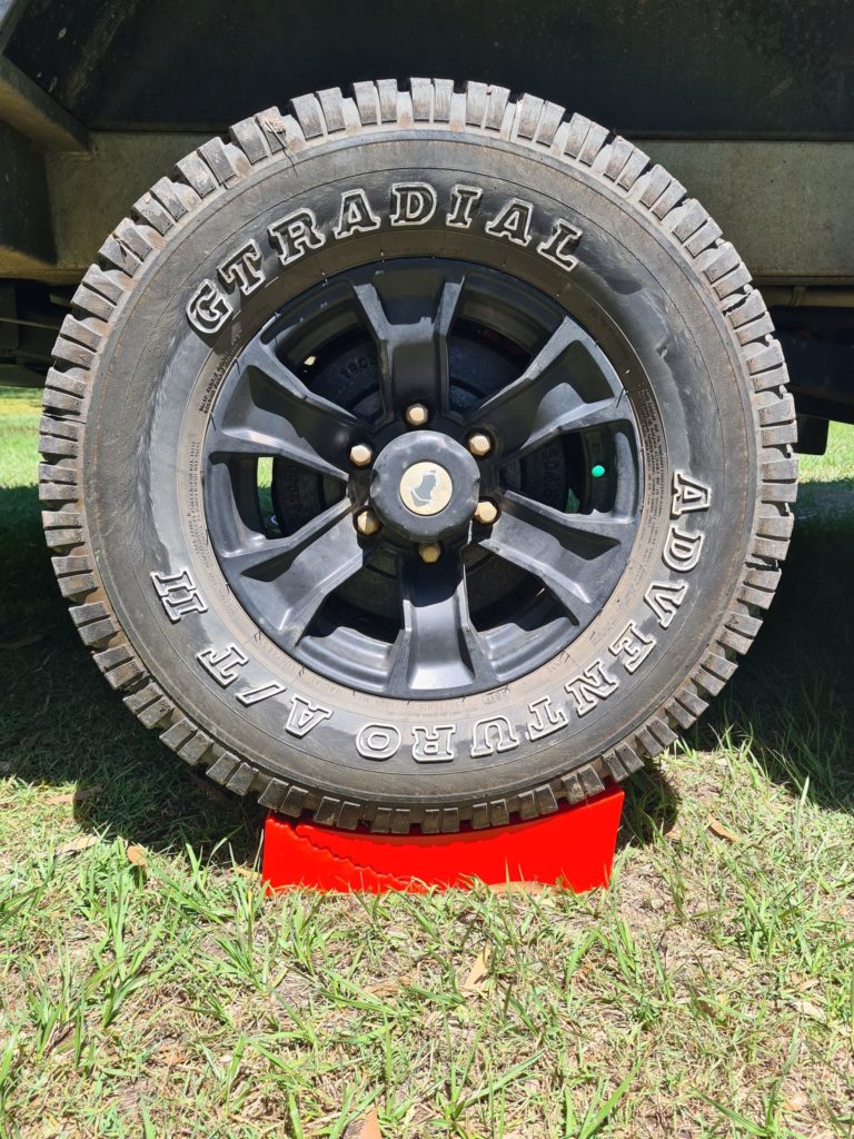 Redfoot Levelling - A Redfoot Levelling Camper Leveller with a tire stand on top of it designed for caravans.