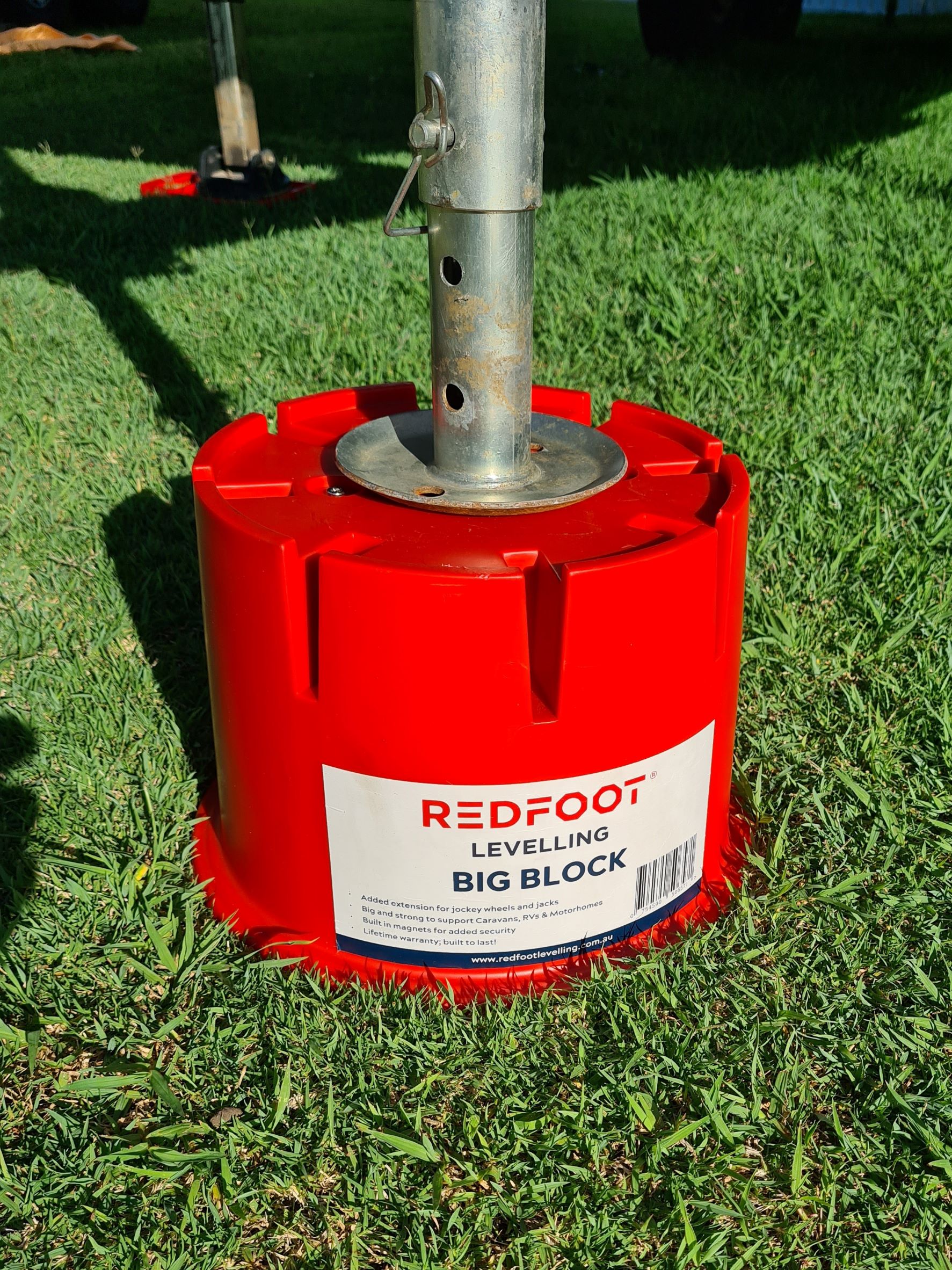 Redfoot Levelling - A red metal pole with a red foot on it.