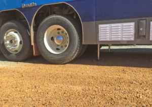 Redfoot Levelling - A medium-sized blue Medium/Heavy Ridged Vehicles parked on a dirt road.