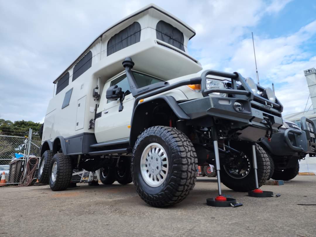 Redfoot Levelling - A white Expedition Off-Road Vehicle with a camper attached to it, suitable for expeditions.
