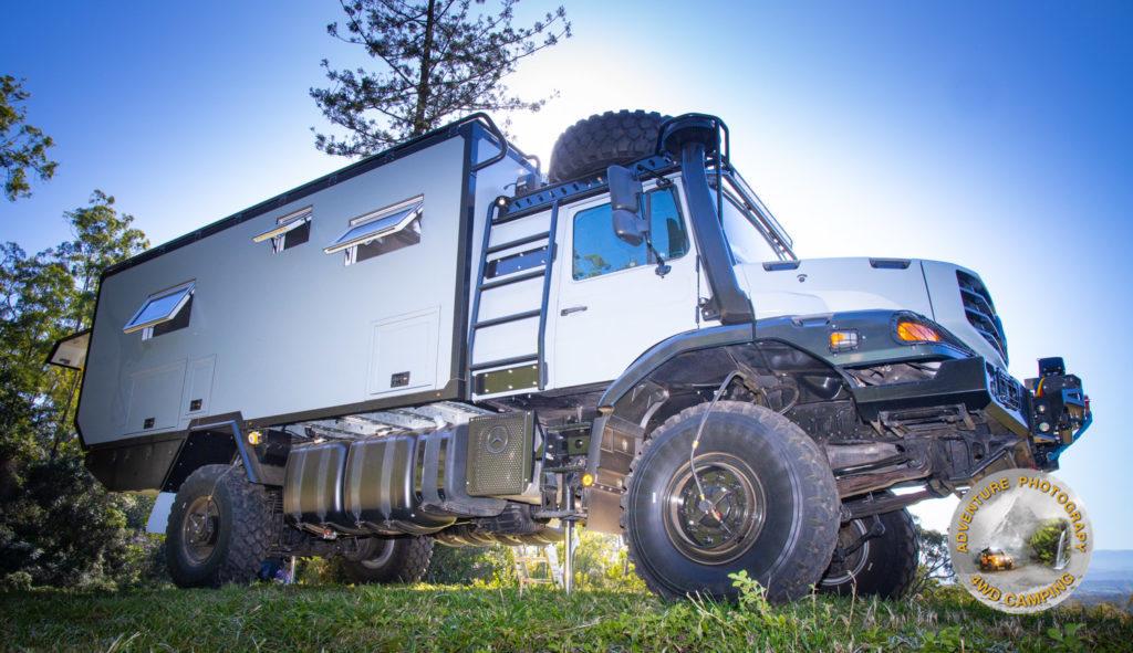 Redfoot Levelling - A white truck with an Expedition Off-Road Vehicles parked in the grass.