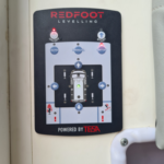 Redfoot Levelling - A Redfoot Levelling Renault ‘AutoLift’ System boat with a power button on it.