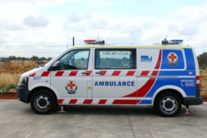 Redfoot Levelling - A blue and white ambulance parked in front of a field.