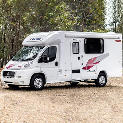 Redfoot Levelling - A Redfoot Levelling Fiat 'AutoLift' System modifies a white rv parked on a dirt road.